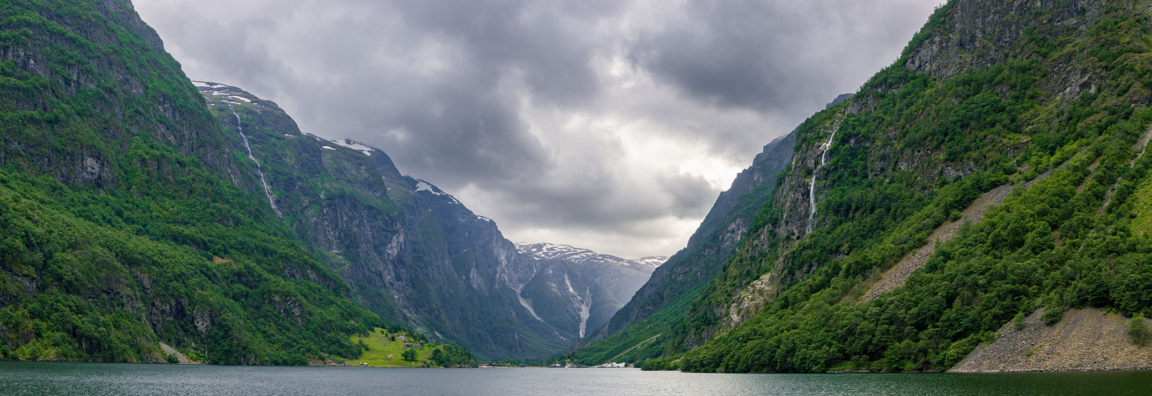 A fjord with steep cliffs and waterfalls.