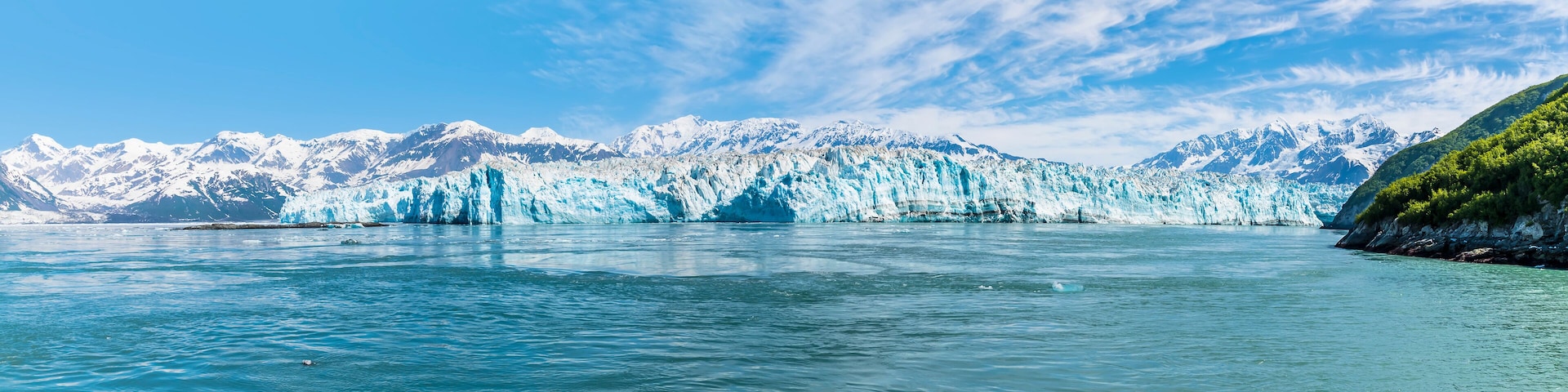A panorama view of the end of the Hubbard Glacier in Disenchartment Bay, Alaska in summertime