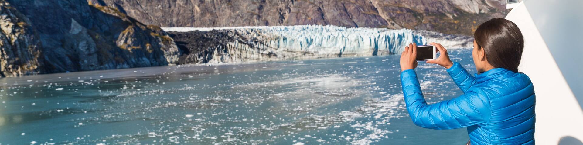 Alaska cruise tourist taking photo of Glacier Bay. Ship passenger on balcony looking at view taking smartphone pictures of Margerie glacier from boat. Woman using phone app on travel vacation., Shutte