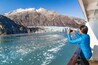 Alaska cruise tourist taking photo of Glacier Bay. Ship passenger on balcony looking at view taking smartphone pictures of Margerie glacier from boat. Woman using phone app on travel vacation., Shutte