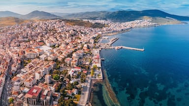 Drone panorama capturing the beauty of Dikili, a coastal town in Turkey, showcasing its colorful buildings, harbor, and the clear Aegean Sea
