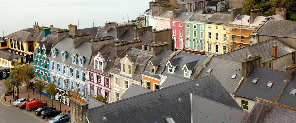 A waterfront town with colorful buildings and a calm river.