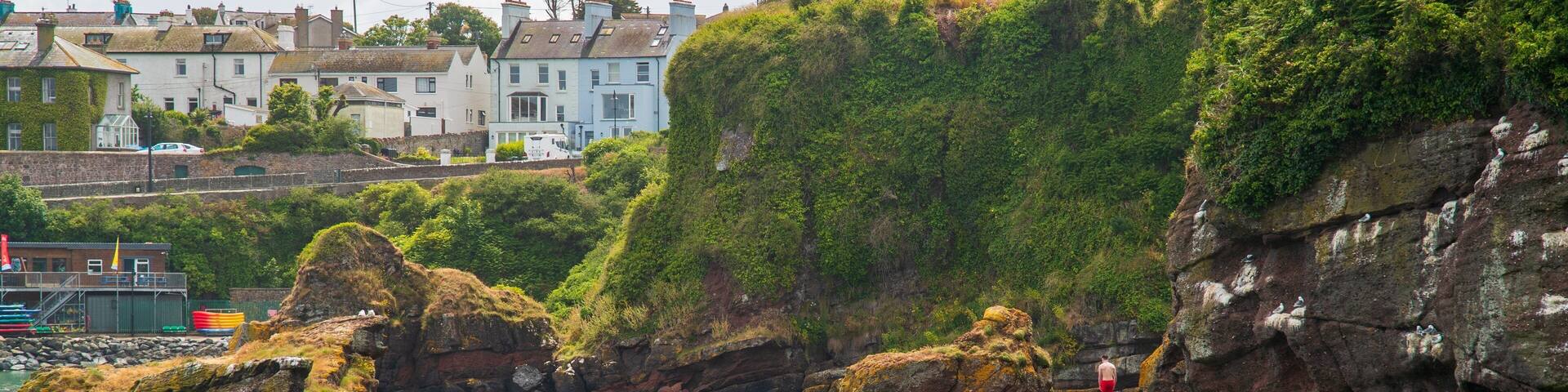 Dunmore East which includes rocky coastline and general coastal views