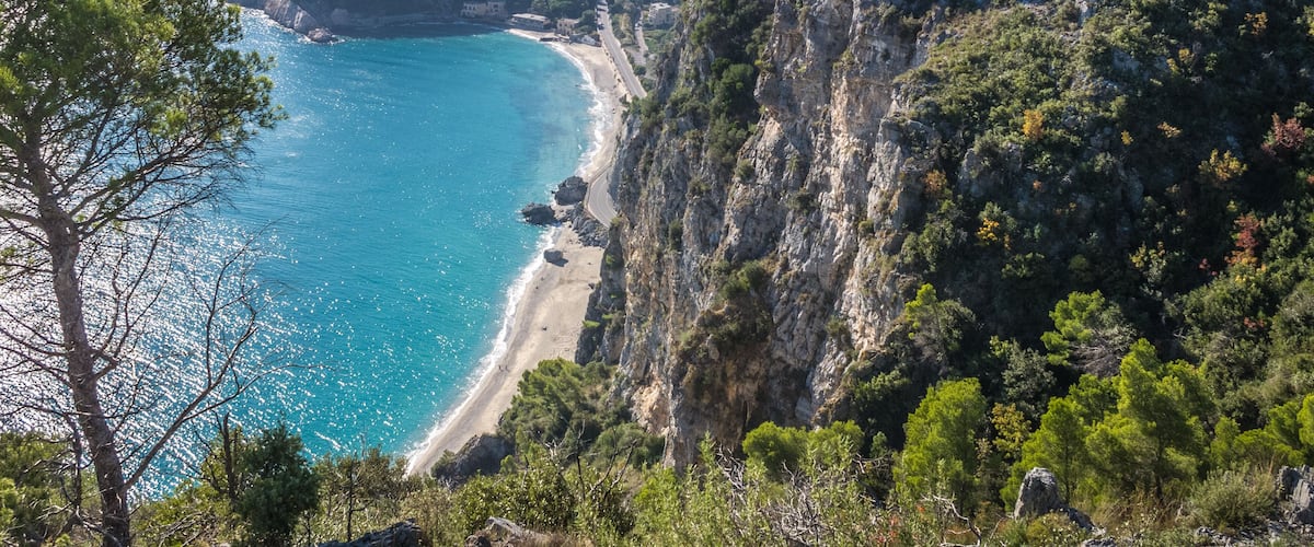 Beautiful aerial view of Baia dei Saraceni with blue Mediterranean sea and a stone watchtower near Varigotti, quaint fisherman village near Finale Ligure, Savona, Liguria, Italy, Italian Riviera