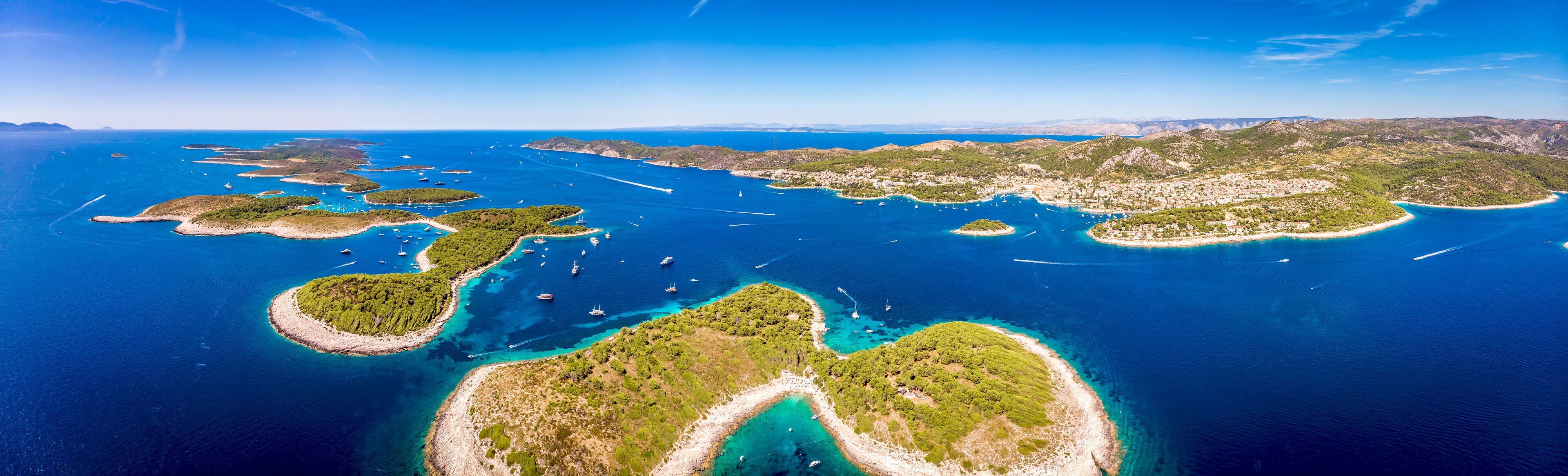 An aerial view of a coastal region with multiple islands surrounded by clear blue waters.