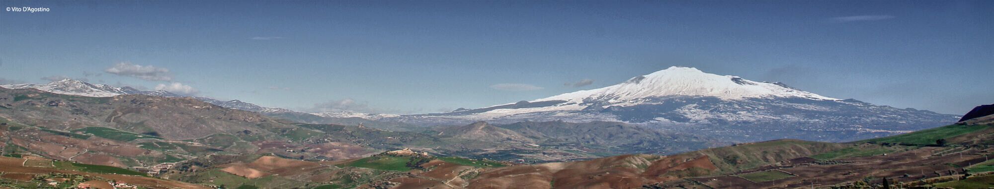A snow-capped mountain with a clear sky.