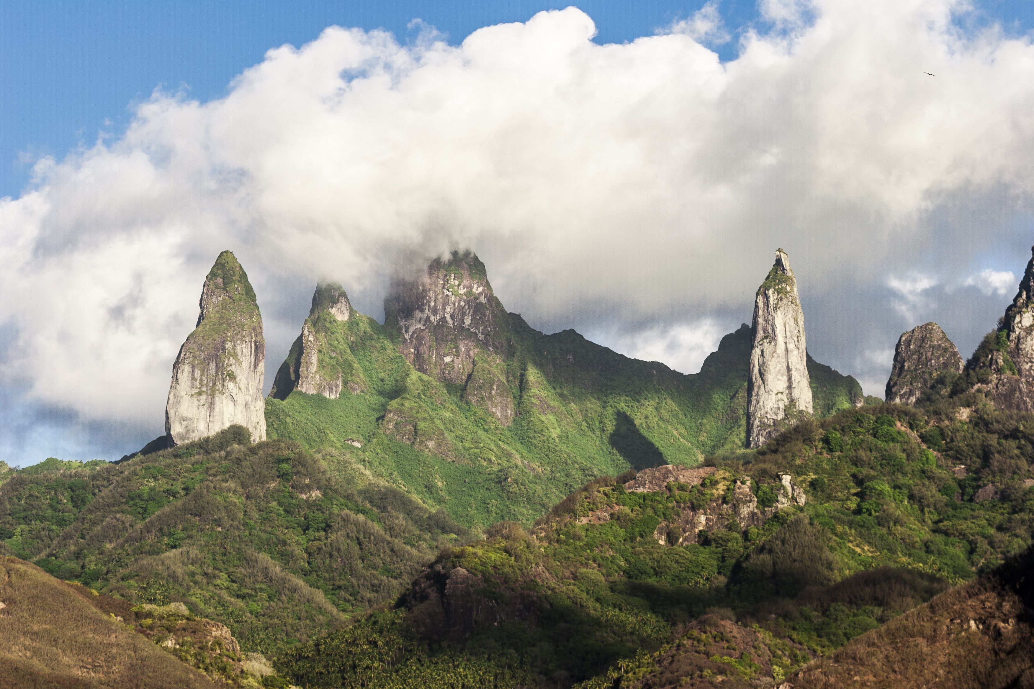 A mountainous landscape with prominent rock formations and lush green vegetation.