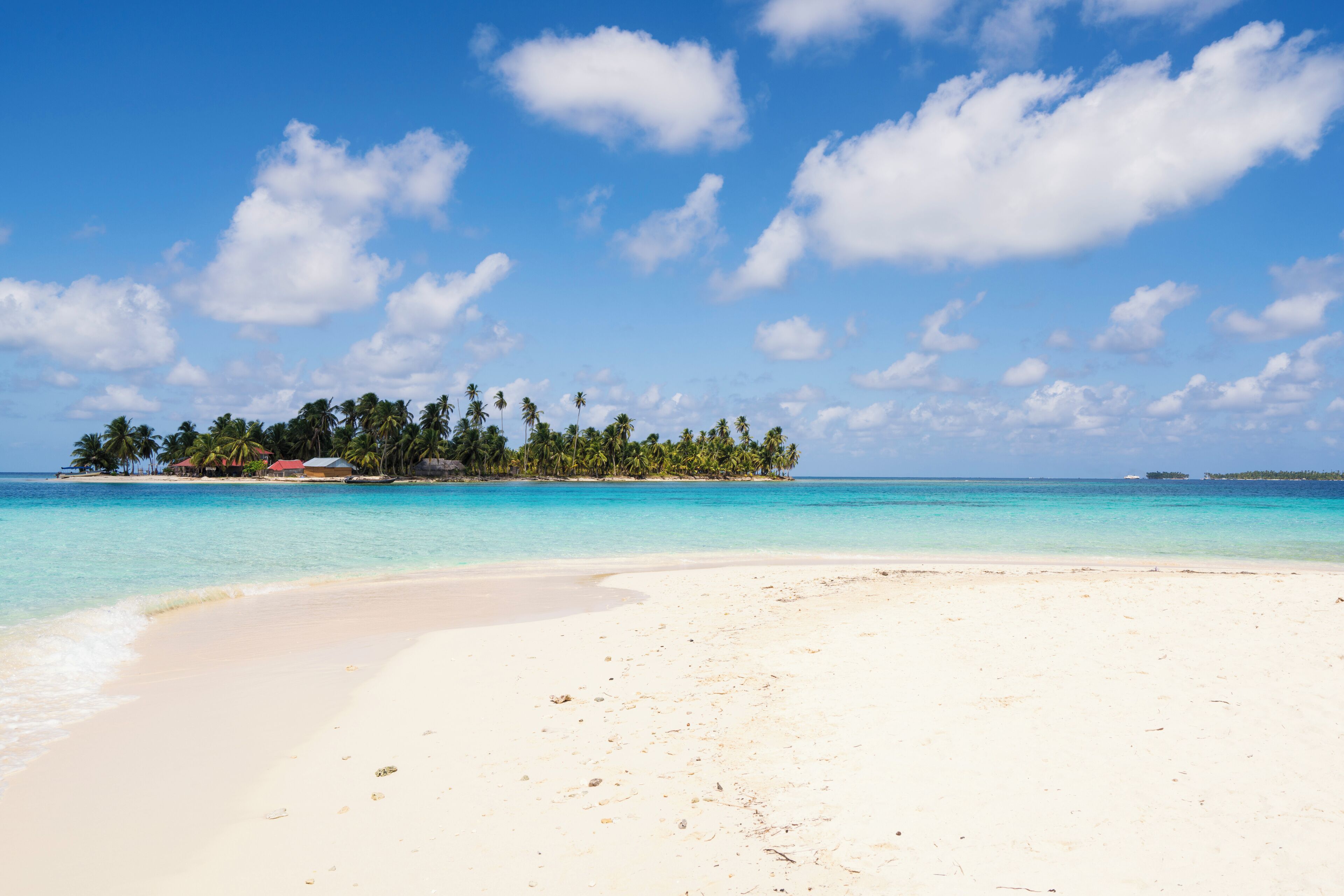 View of turquoise sea with island from Isla de  Perro island in Caribbean See