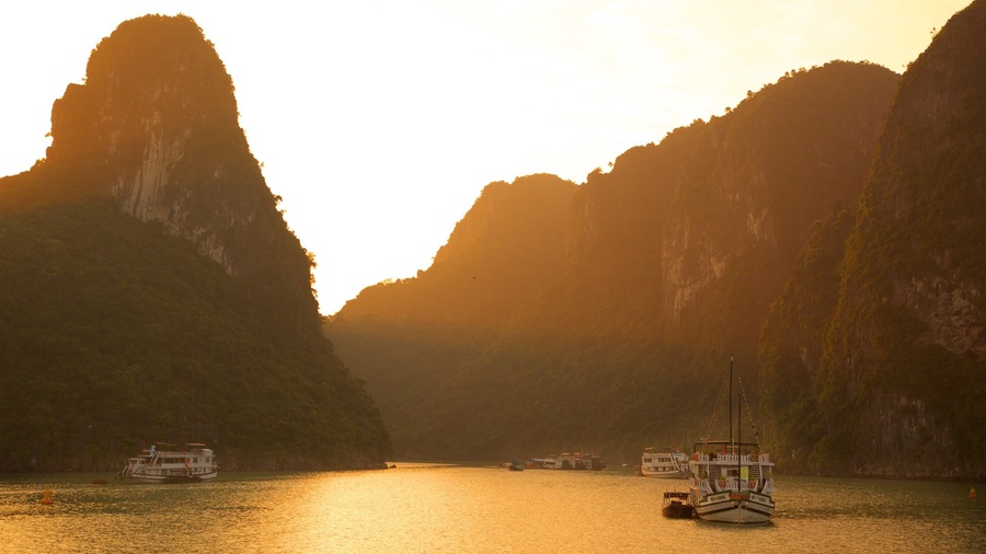 Halong Bay featuring a sunset and a bay or harbor