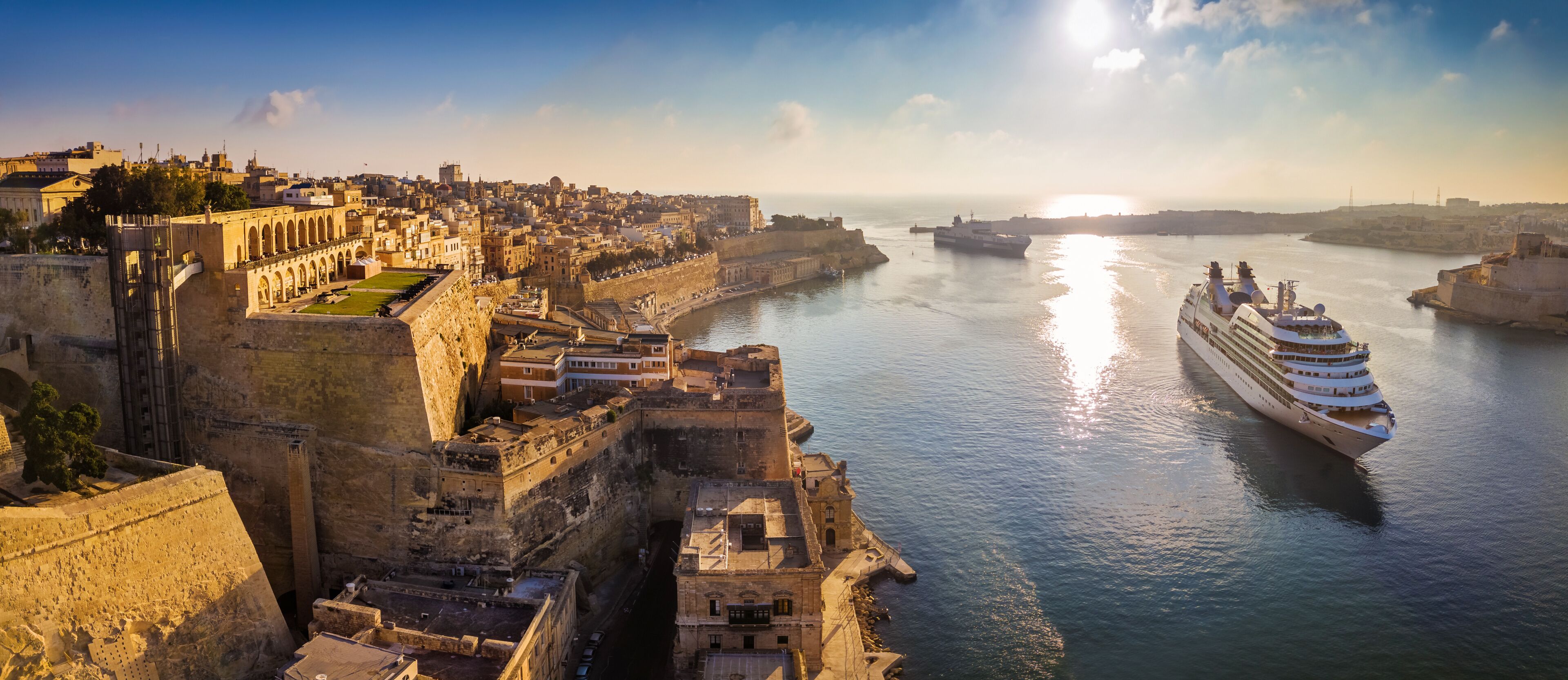 Valletta, Malta - Panoramic aerial skyline view of Valletta when cruise ships sailing in the Grand harbor at surnise