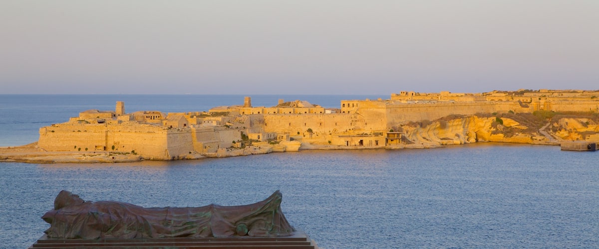 Grand Harbour which includes a bay or harbor, a sunset and a coastal town