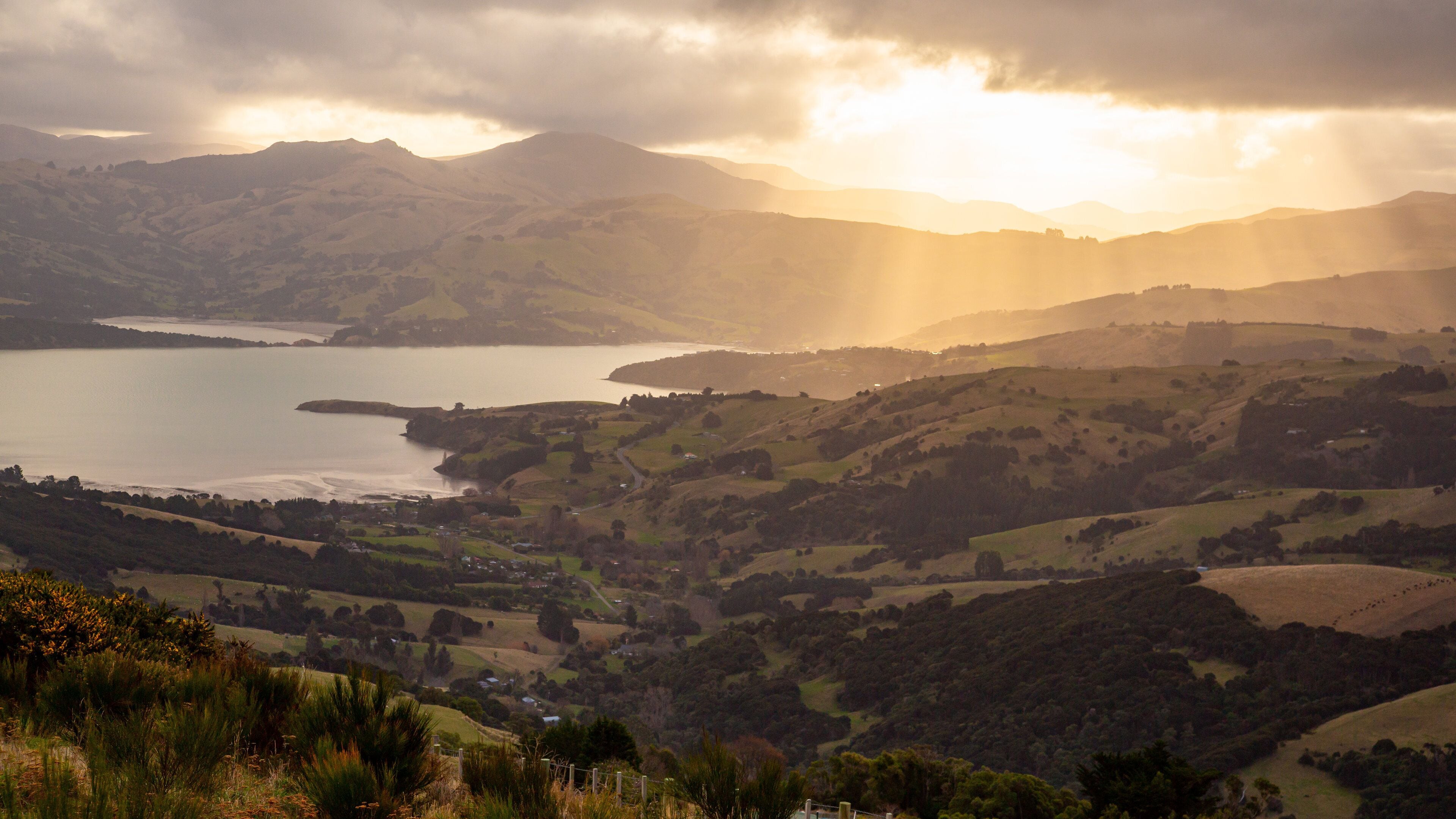 Akaroa which includes a river or creek, tranquil scenes and a sunset