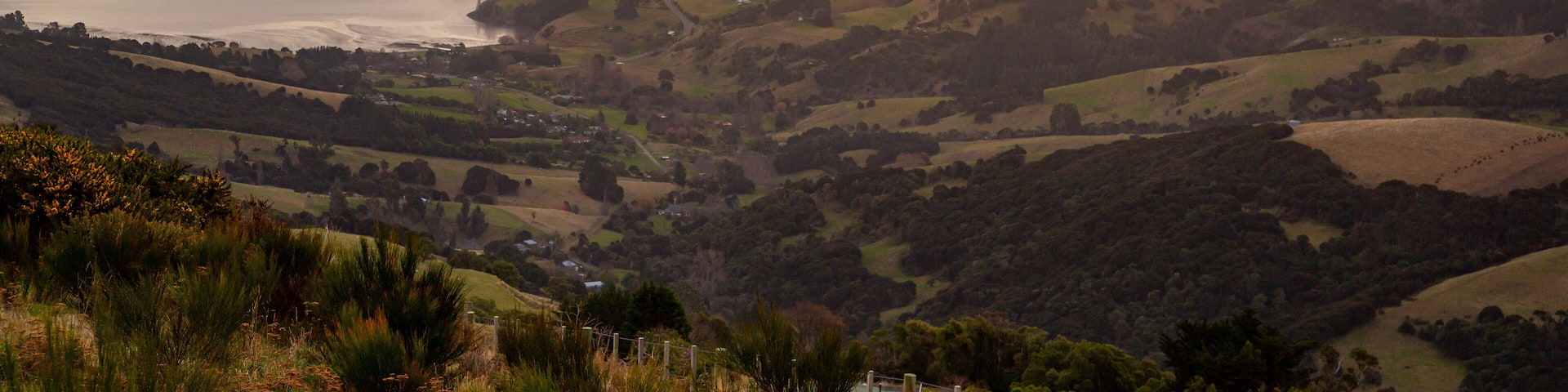 Akaroa which includes a river or creek, tranquil scenes and a sunset