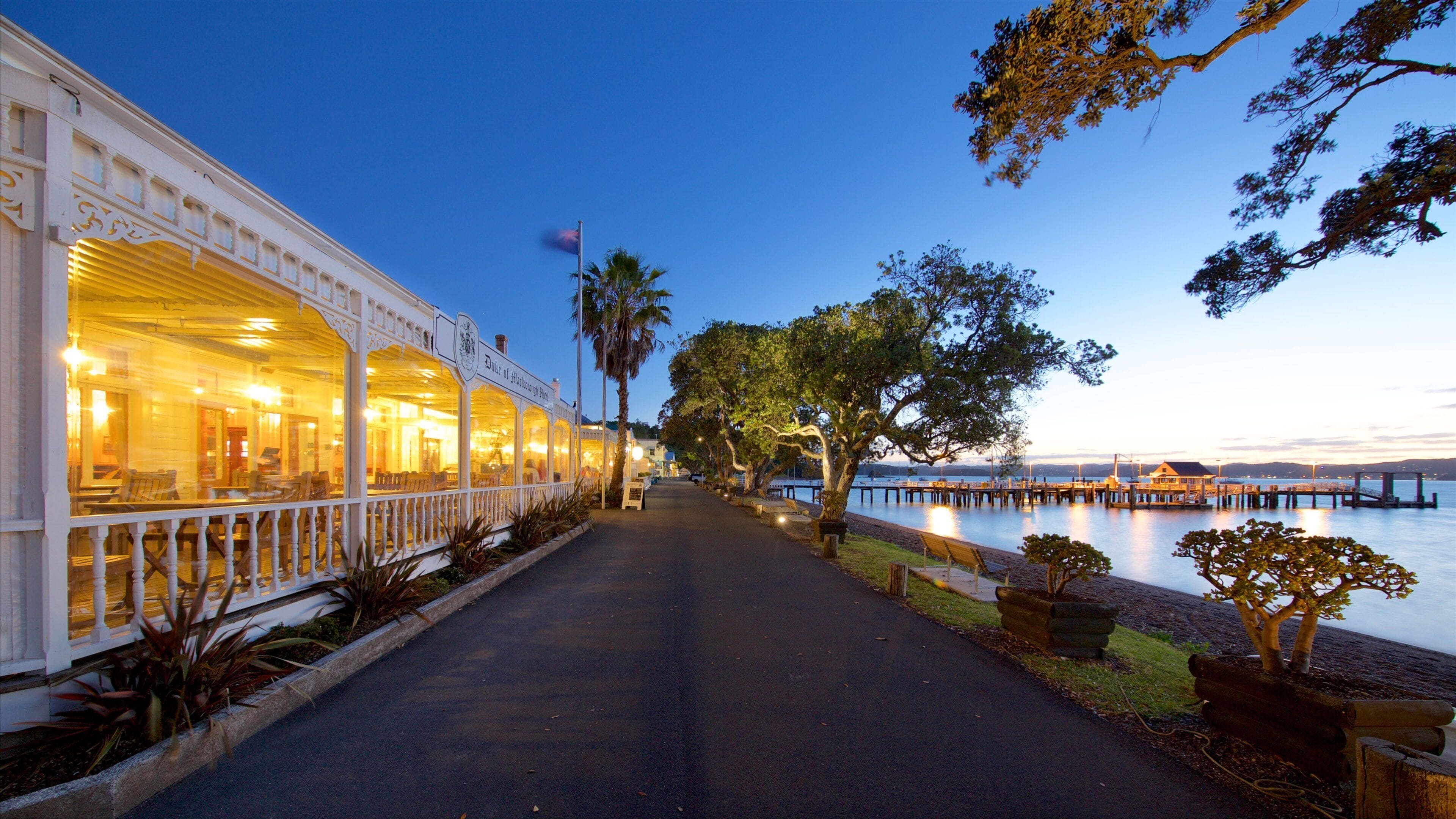 A waterfront restaurant with outdoor seating and a view of the water.