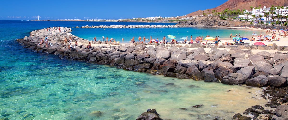 Playa Blanca which includes general coastal views and a sandy beach