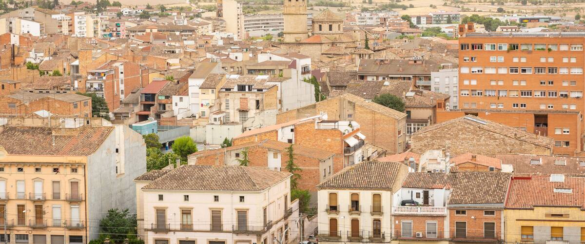 A densely built urban area with historic buildings and a prominent tower.