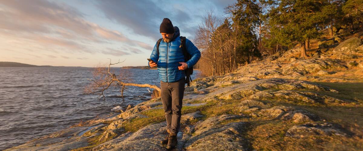 Man walking along coastline in Jarfalla, Sweden