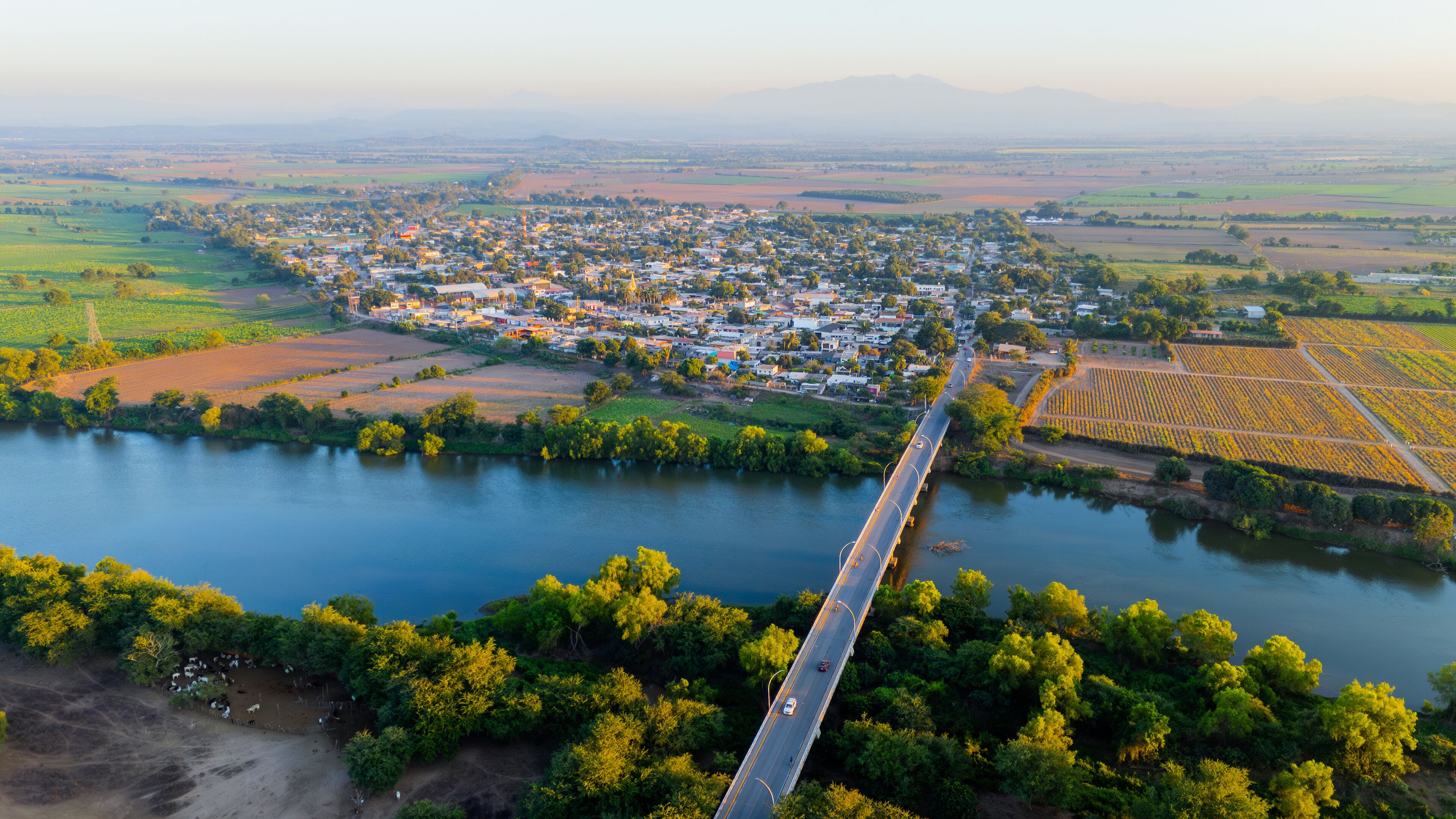 Santiago River flows through the town of La Presa with a bridge connecting the communities in Nayarit, Mexico
