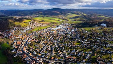 A town nestled in a valley surrounded by hills and fields.
