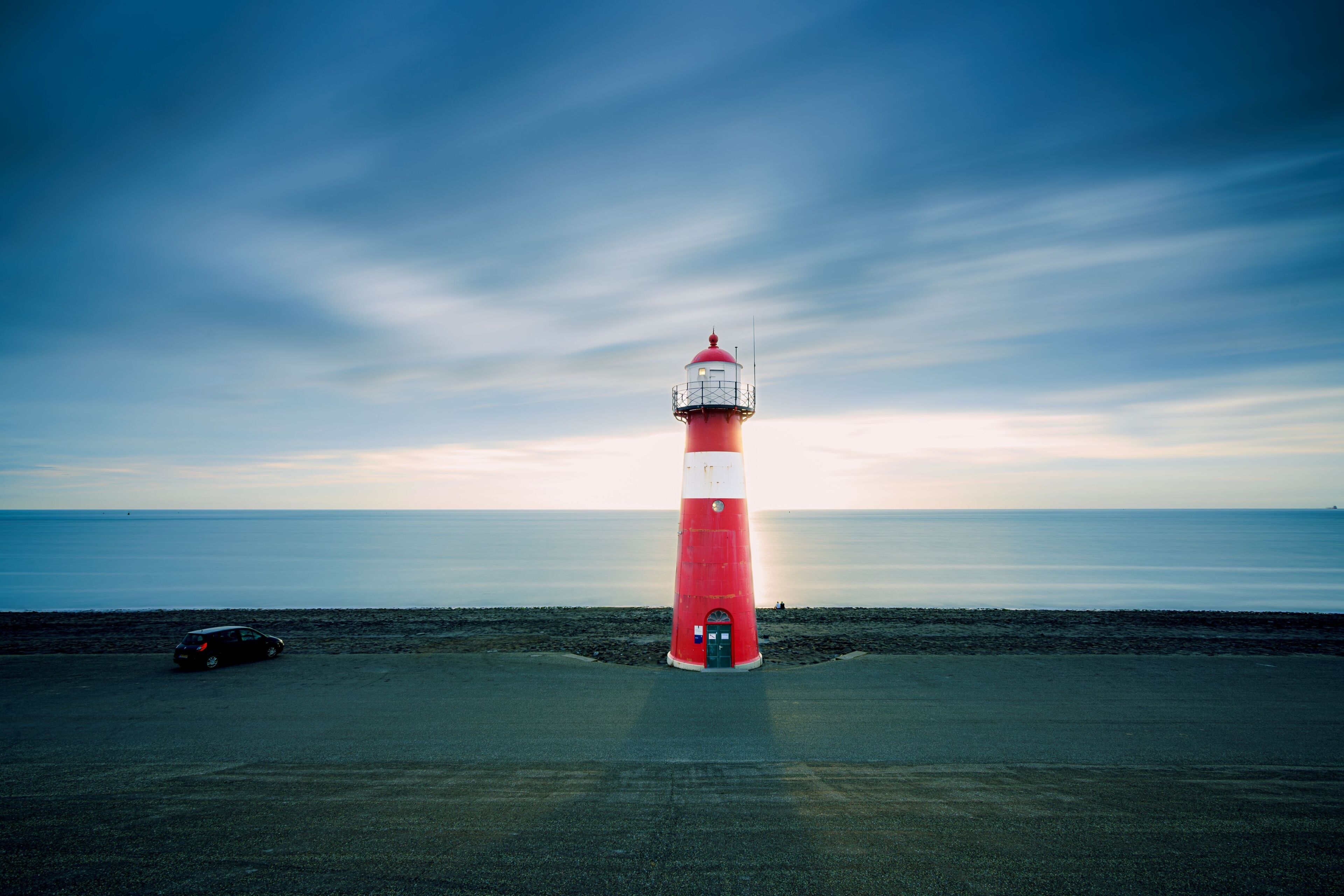 Red & white vintage lighthouse at dutch coast in west kapelle