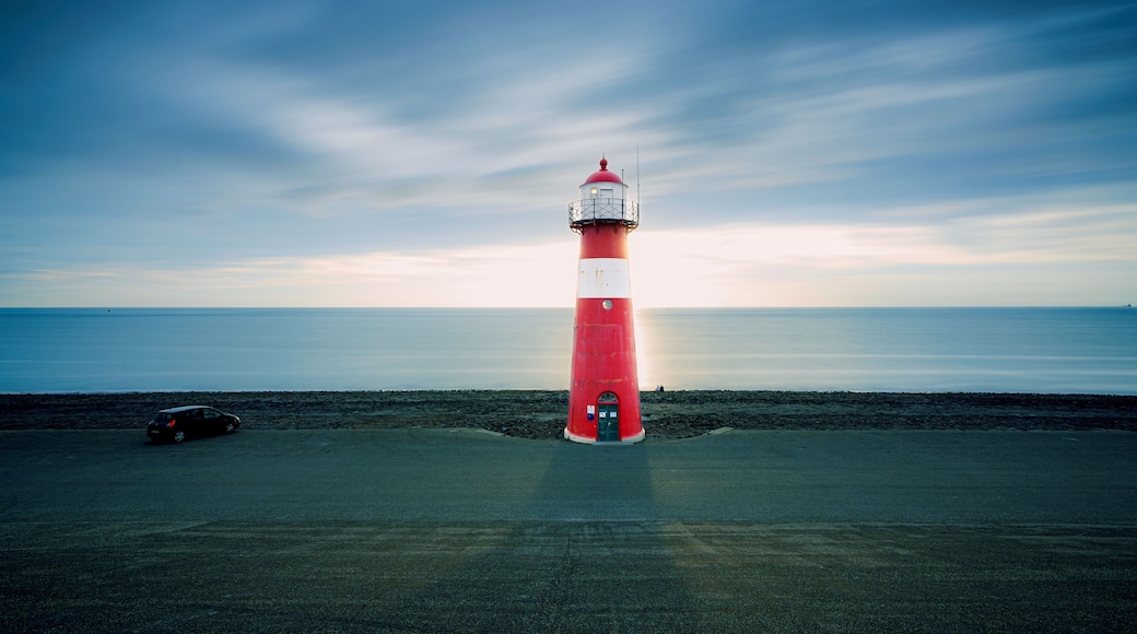 Red & white vintage lighthouse at dutch coast in west kapelle