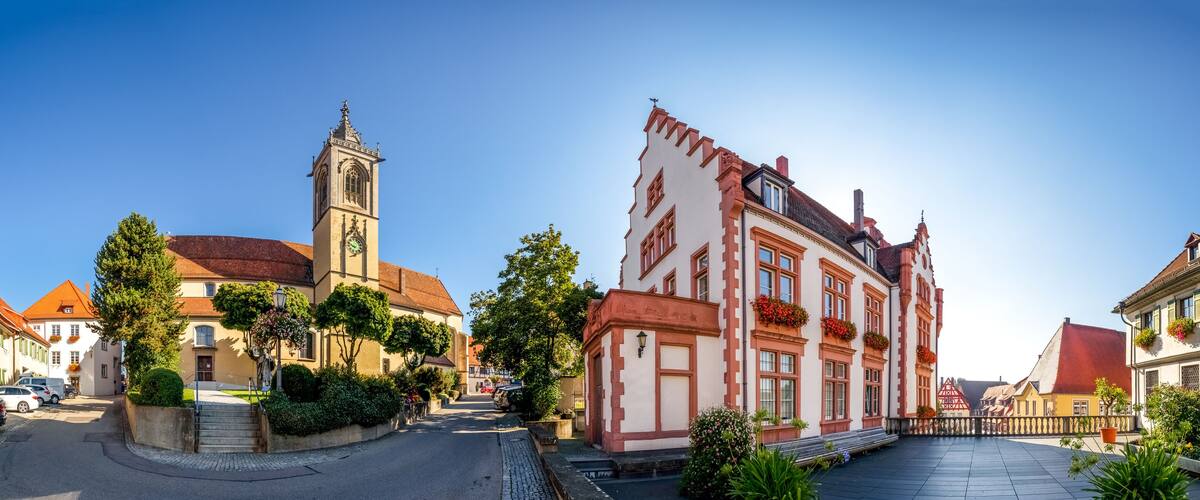 A historic street with a clock tower and traditional buildings.