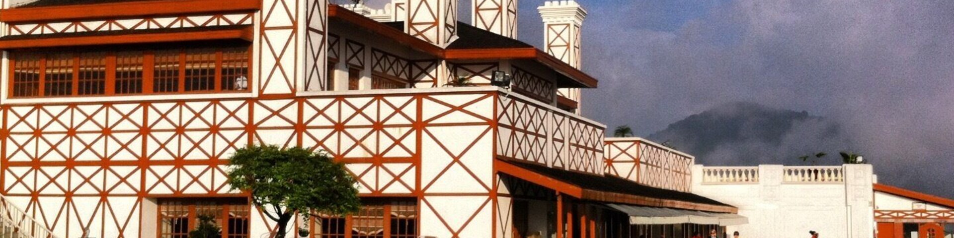 A large building with a distinctive geometric facade and multiple chimneys.