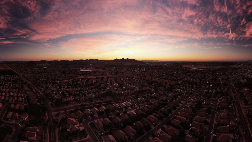 An aerial view of a residential area with a sunset sky.
