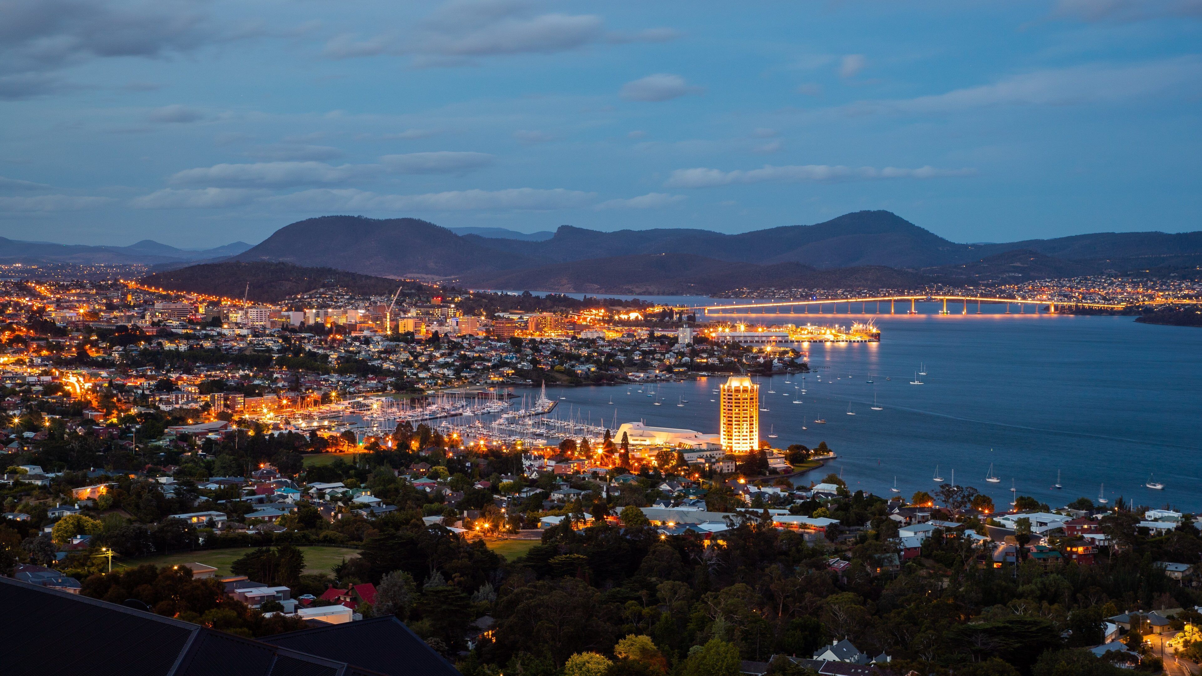 Sandy Bay which includes night scenes, a bay or harbor and landscape views