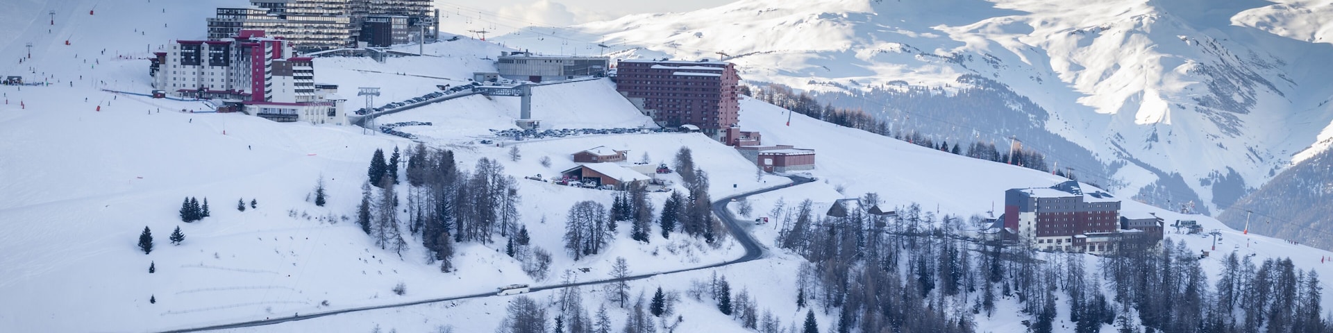 View of La Plagne Aime 2000 ski resort in French Savoy Alps. Snow covered mountains and buildings of ski apartments