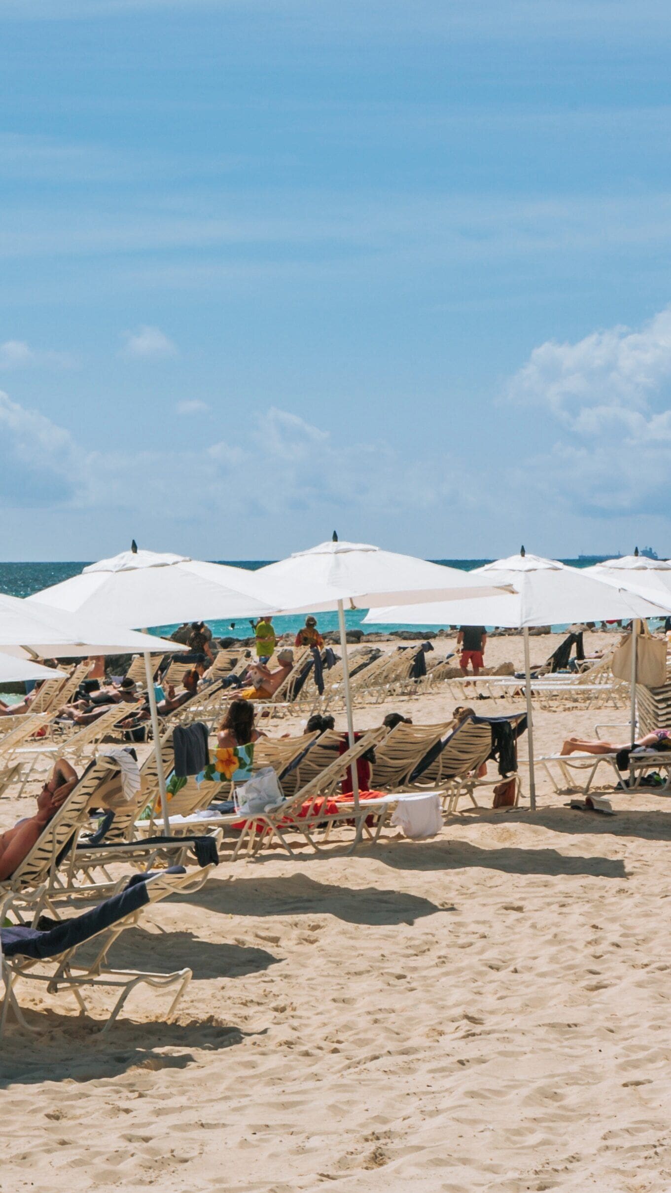 Relaxation and leisure at Lucaya Beach in Freeport, West Grand Bahama under clear skies and bright sun