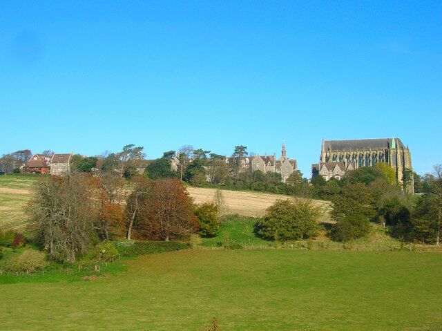 A rural landscape with a prominent church and residential buildings.