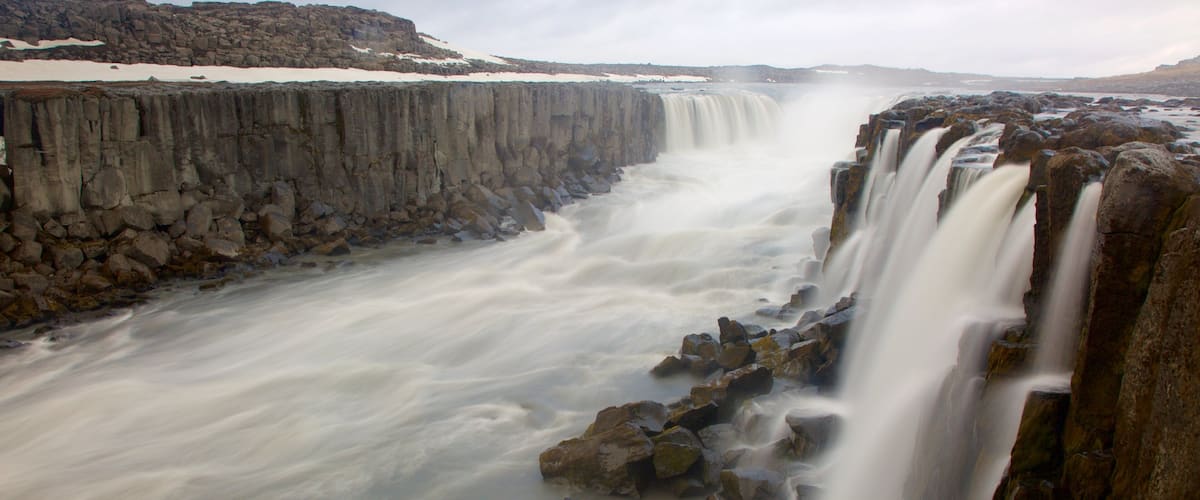 A large waterfall cascading over a rocky cliff.