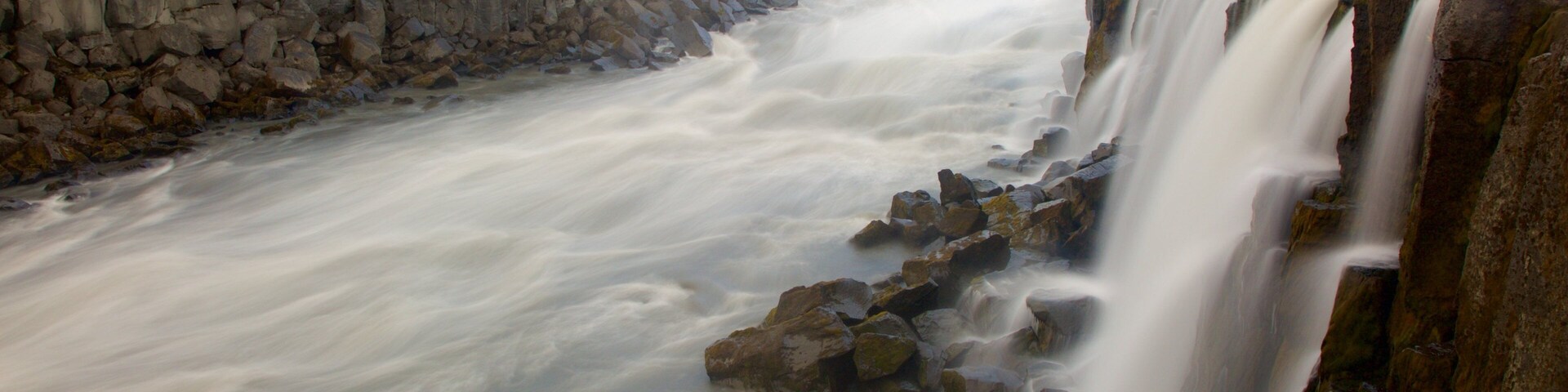 A large waterfall cascading over a rocky cliff.