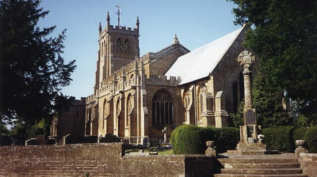 All Saints' parish church, Martock, Somerset, seen from the southeast. The stone cross on the right is the parish war memorial.
