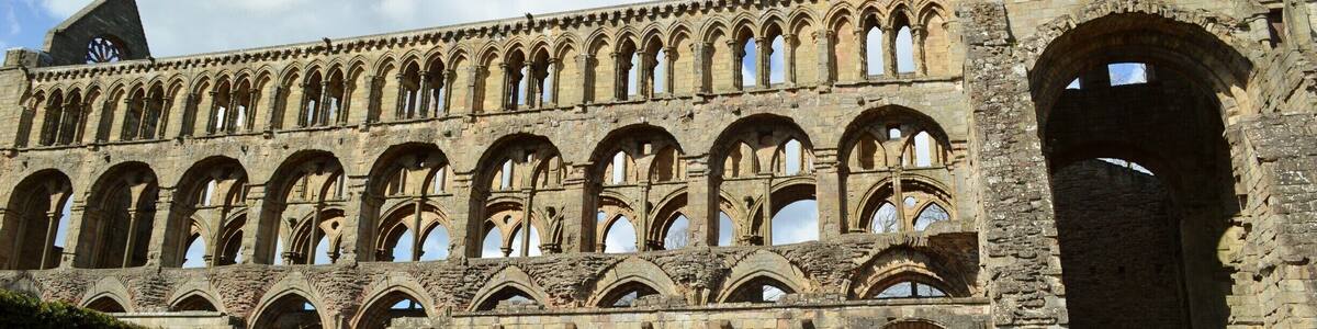 Jedburgh Abbey, a ruined Augustinian abbey which was founded in the 12th century, is situated in the town of Jedburgh, in the Scottish Borders 10 miles (16 km) north of the border with England at Carter Bar. Jedburgh is the largest town on the A68 between Newcastle upon Tyne and the Scottish capital, Edinburgh