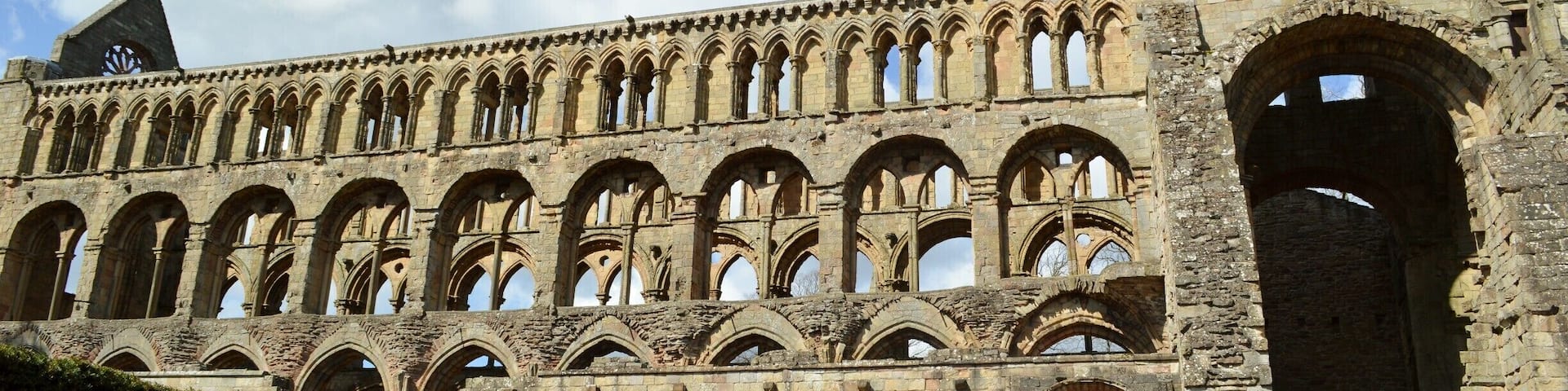 Jedburgh Abbey, a ruined Augustinian abbey which was founded in the 12th century, is situated in the town of Jedburgh, in the Scottish Borders 10 miles (16 km) north of the border with England at Carter Bar. Jedburgh is the largest town on the A68 between Newcastle upon Tyne and the Scottish capital, Edinburgh