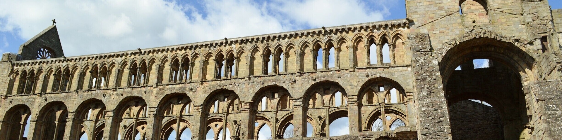 Jedburgh Abbey, a ruined Augustinian abbey which was founded in the 12th century, is situated in the town of Jedburgh, in the Scottish Borders 10 miles (16 km) north of the border with England at Carter Bar. Jedburgh is the largest town on the A68 between Newcastle upon Tyne and the Scottish capital, Edinburgh