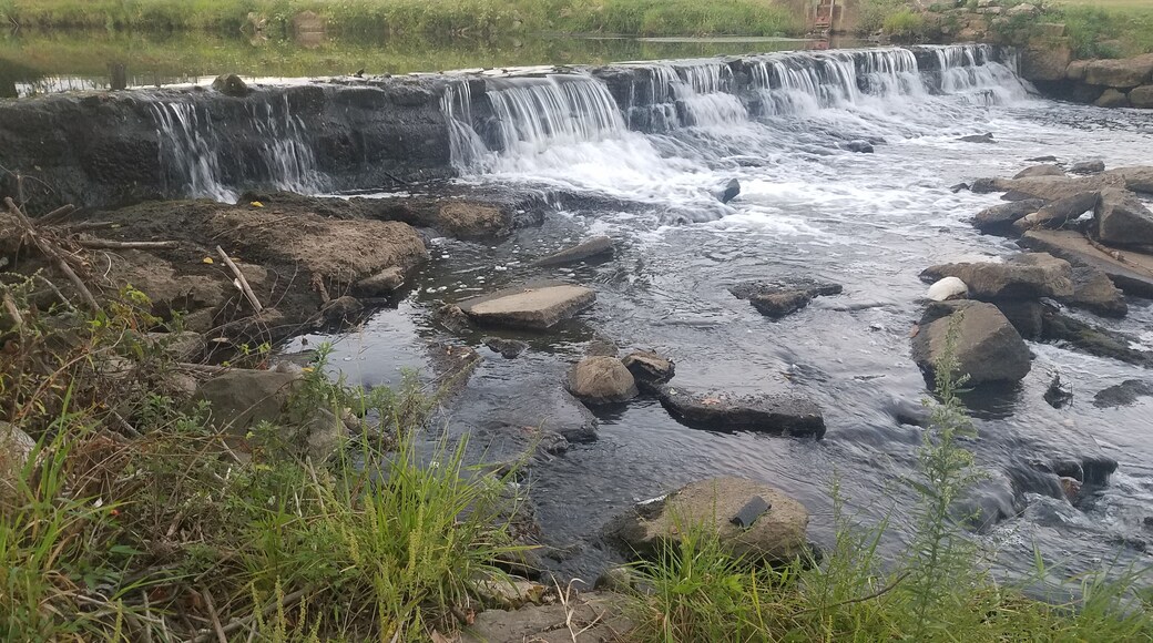 A small waterfall over a man made dam. One of several I came across while walking the path alongside the creek.