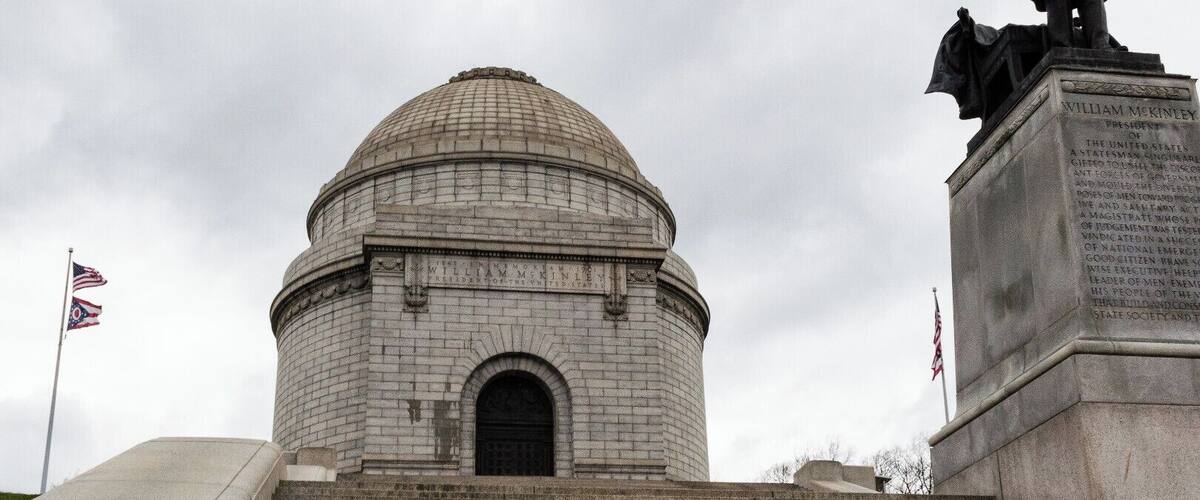 The William McKinley Memorial is a Canton, Ohio landmark, and is the final resting place of the 25th U.S. President and his wife Ida. The site also houses the William McKinley Presidential Library and Museum and a large public park.
McKinley was born in Niles, Ohio but began his career in Canton, the city he called home. McKinley was also the 39th Governor of Ohio. On September 6th 1901, six months into his second term as President, McKinley was shot by a Polish American anarchist. He died 8 days later on September 14th. He was succeeded by his vice president Theodore Roosevelt. The monument, which has 108 steps leading up to its doors, is a very popular destination for area fitness fans who jog up and down the steps throughout the day.
https://mckinleymuseum.org/mckinley-memorial/