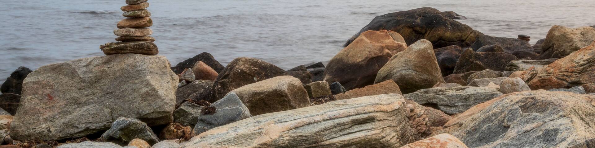 Stone cairn on the ocean shore in Connecticut, USA, near Harkness Memorial State Park
