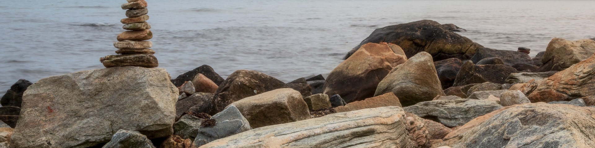 Stone cairn on the ocean shore in Connecticut, USA, near Harkness Memorial State Park