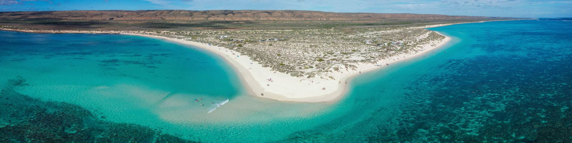 Aerial view of turquoise bay with pristine beach and coral reef, Exmouth, Australia.