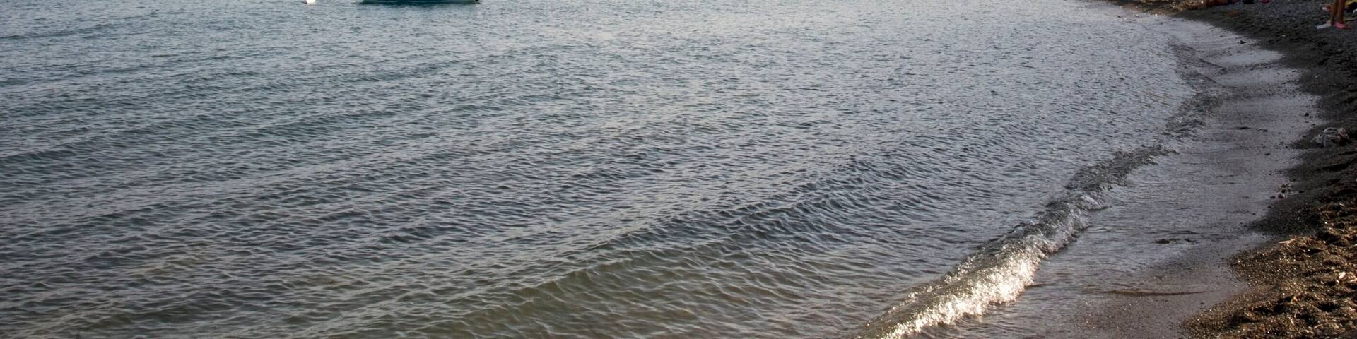 Breakwater and mole with the mount Bulgheria in the background at sunset. Scario village in the Policastro gulf, Salerno, Italy, Europe