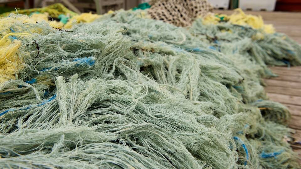 A pile of fishing nets in various colors.