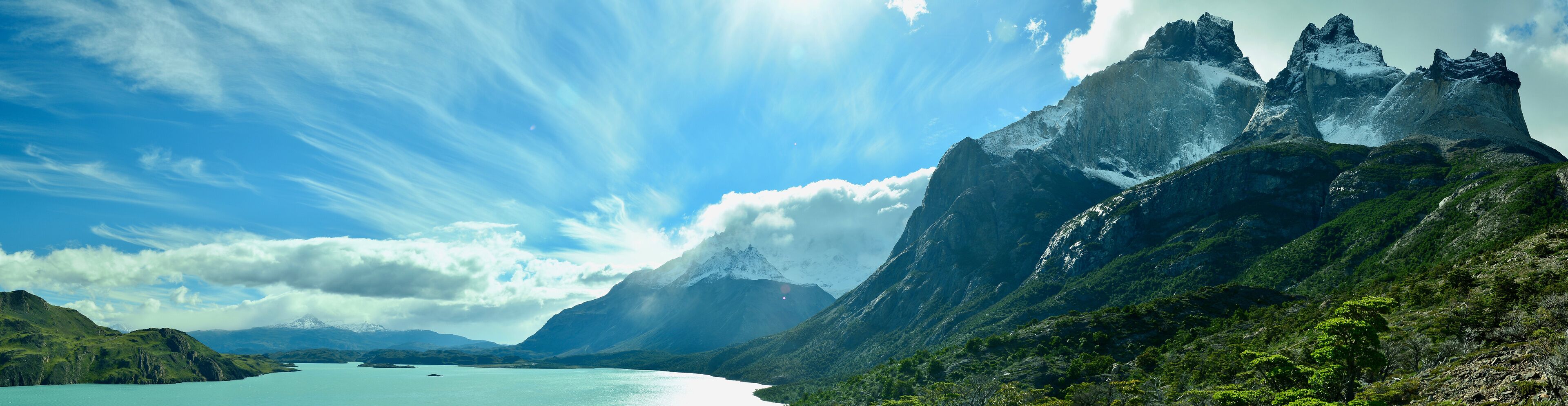 A mountainous landscape with a lake and a clear sky.
