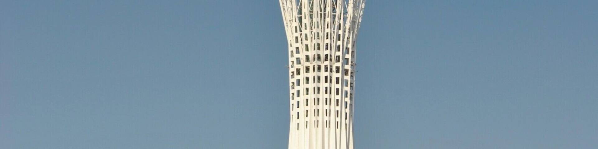 A tall tower with a spherical top and a white lattice structure.