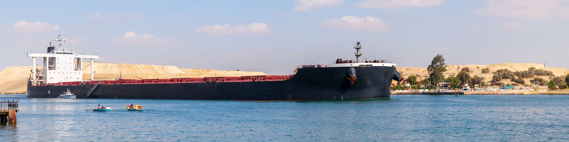 Bulk carrier ship with black hull passes the Suez Canal