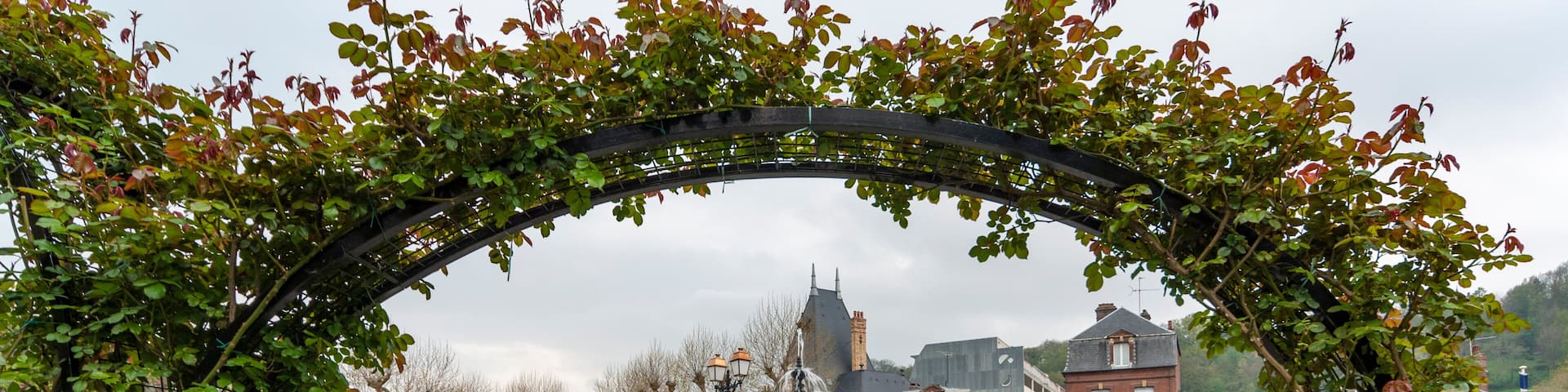 Fountain and blooming flowers at Place Albert Sorel in Honfleur, France