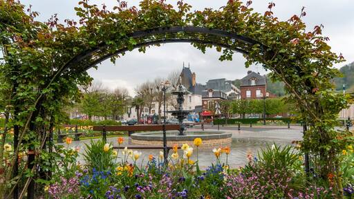 Fountain and blooming flowers at Place Albert Sorel in Honfleur, France